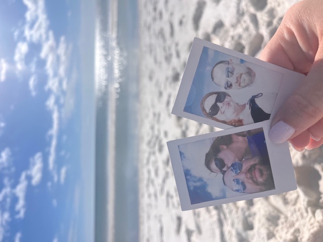 Two snapshots of Krystal and Joe held up against a sunny beach