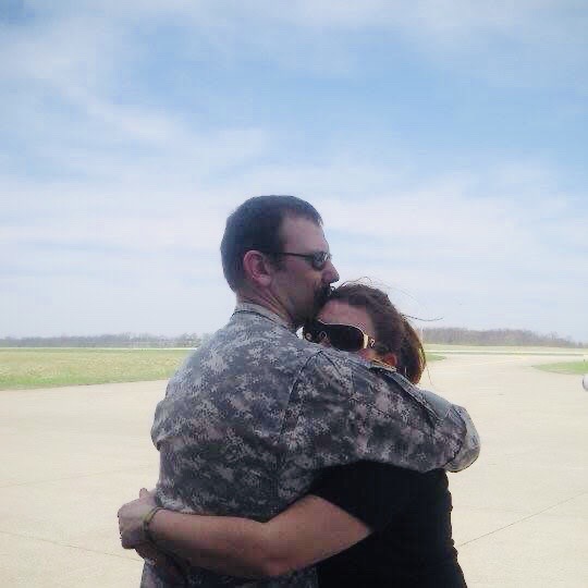 Krystal and Joe embracing during his military service