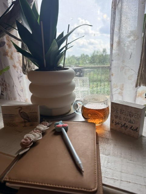 Krystal’s tea beside her journal at a sunlit window